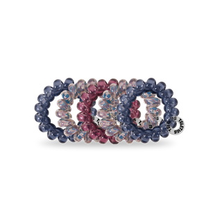 TELETIES spiral hair coils in translucent blue, pink, and iridescent colors on white background