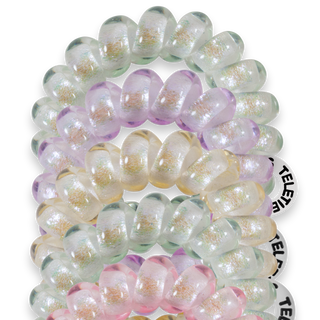 Five translucent spiral hair coils with iridescent shimmer in pastel colors arranged on black background
