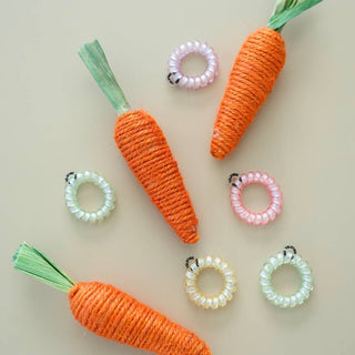 TELETIES spiral hair coils displayed with decorative orange rope carrots on neutral background