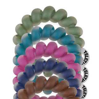 Stack of coiled spiral hair ties with frosted finish displayed against black background.