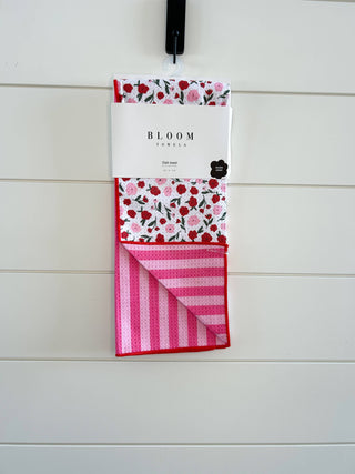 Bloom Towels Sweet Blooms Kitchen Towel with floral pattern and pink striped design hanging on white wall