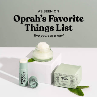 Poppy & Pout Sweet Mint lip balm and exfoliating lip scrub products displayed with mint leaves and cream jar.