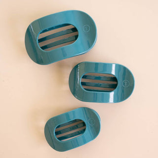 Three TELETIES flat round hair clips in graduated sizes displayed on a neutral background.