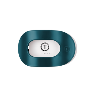 TELETIES branded flat round hair clip with white center panel and circular logo on dark background.