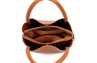 Open tan leather satchel bag showing interior compartments with zipper divider and dual handles