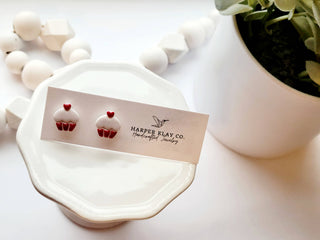 Harper Klay Co cupcake stud earrings displayed on white ceramic plate with product card and floral background