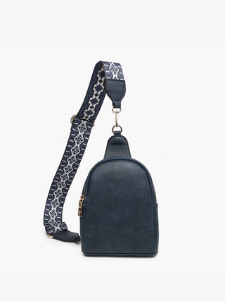 Navy blue sling bag with decorative patterned strap and gold zipper hardware