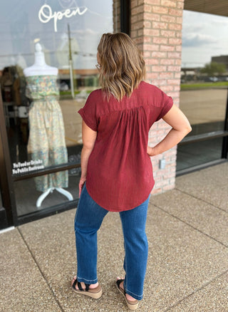 Woman wearing Blu Pepper Timeless Stripe Blouse with jeans, back view, outside boutique.