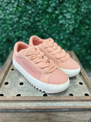 TOMS Rea Bloom Open Weave Sneakers in pink mesh material on wooden surface with green foliage background.