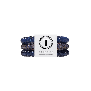 TELETIES spiral hair ties in deep navy and patterned tones, packaged in branded white card.
