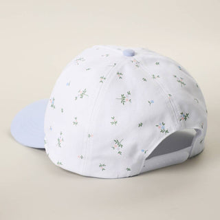 White floral print baseball cap with light blue brim and adjustable back closure.