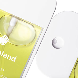 Touchland hand sanitizer bottles with yellow packaging and clear pump dispensers on white background