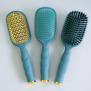 Three TELETIES Vented Hair Brushes with twisted handles, gold accents, and varied bristle designs displayed together.