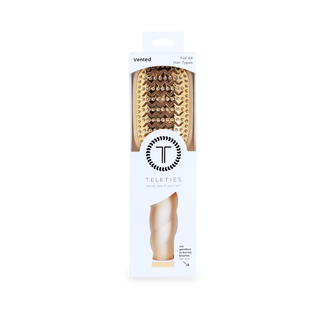 TELETIES vented hair brush in packaging, featuring gold bristles and ergonomic handle design.