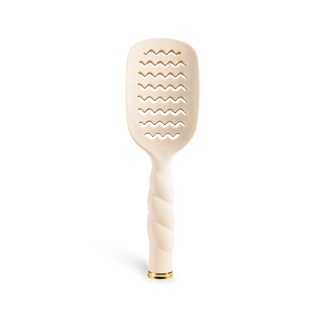 TELETIES vented hair brush with wavy slots, twisted handle, and gold accent tip.