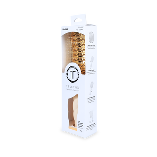 TELETIES vented hair brush in packaging, featuring gold bristle head and ergonomic handle design.