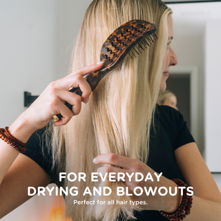 Woman brushing long blonde hair with TELETIES vented tortoise hair brush for blowouts.
