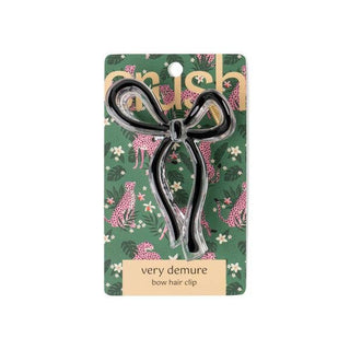 Clear bow-shaped hair clip on decorative green leopard print packaging card