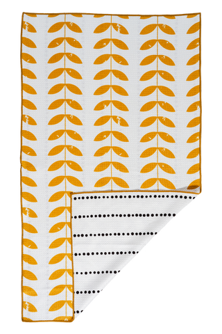 Orange leaf pattern kitchen towel with white background and dotted reverse side, corner folded to show both sides.