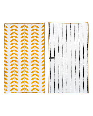 Open kitchen towel displaying orange leaf pattern on one side and dotted grid pattern on reverse side.