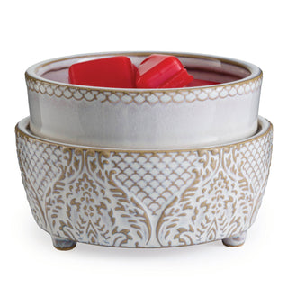 Decorative ceramic fragrance warmer with ornate white pattern and red wax melts inside