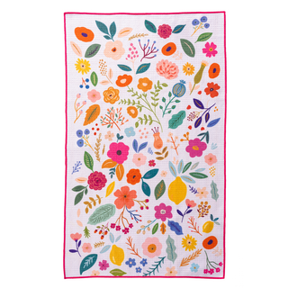 Colorful floral kitchen towel with embroidered wildflowers, leaves, and botanical elements on white background with pink b...